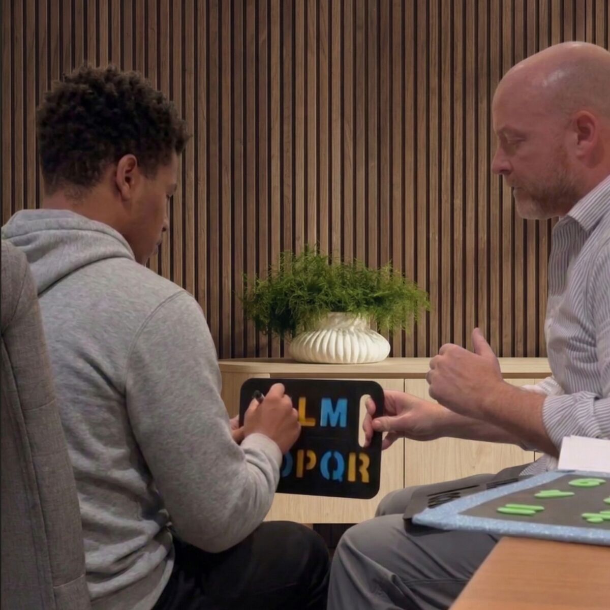 A spelling session using a stencil board